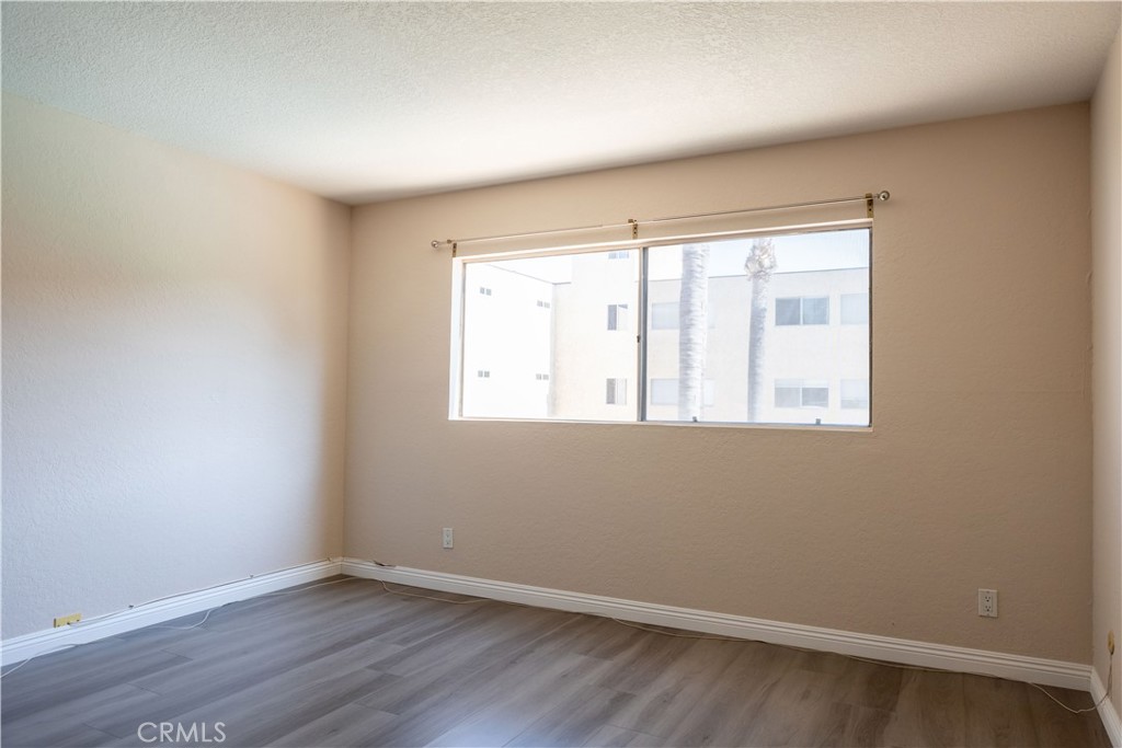 2386 East Del Mar Boulevard, Unit 203 Pasadena, CA 91107 - Photo 14 of 28 an empty room with wooden floor and windows