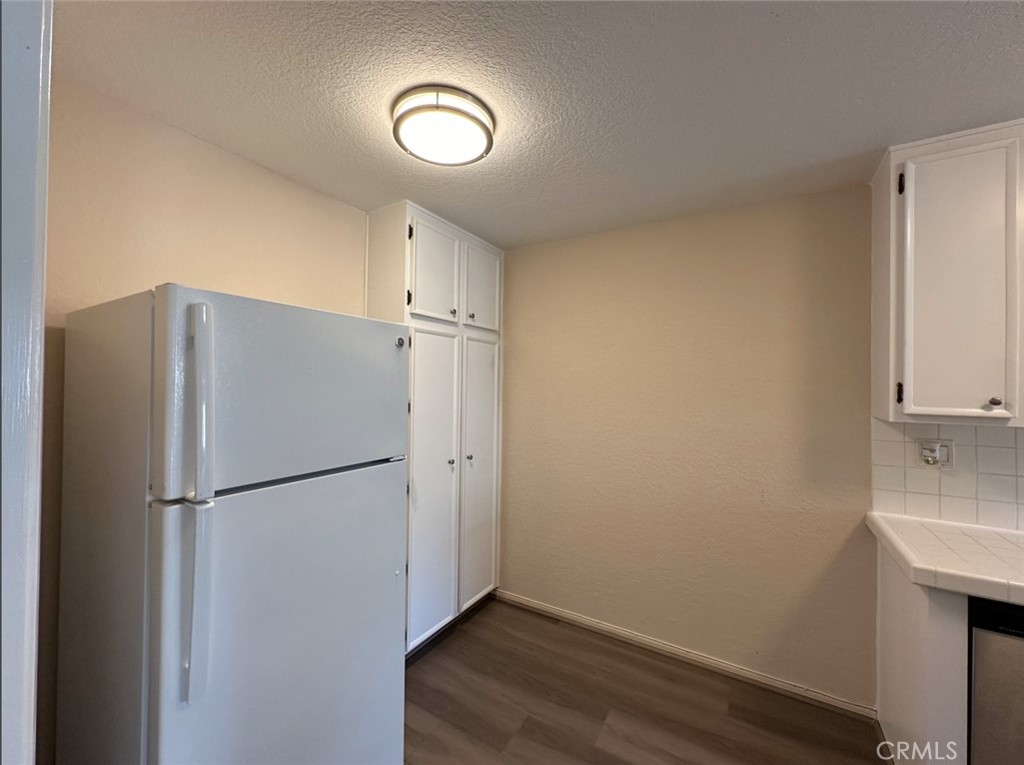 2386 East Del Mar Boulevard, Unit 203 Pasadena, CA 91107 - Photo 15 of 28 a view of a kitchen with a refrigerator and a sink