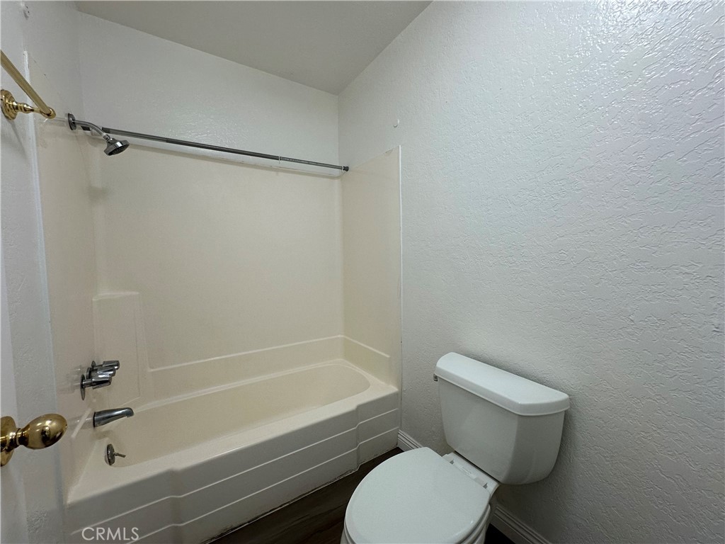 2386 East Del Mar Boulevard, Unit 203 Pasadena, CA 91107 - Photo 20 of 28 a white toilet and tub sitting next to a bathroom sink