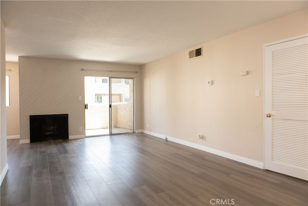 2386 East Del Mar Boulevard, Unit 203 Pasadena, CA 91107 - Photo 2 of 28 an empty room with wooden floor and windows