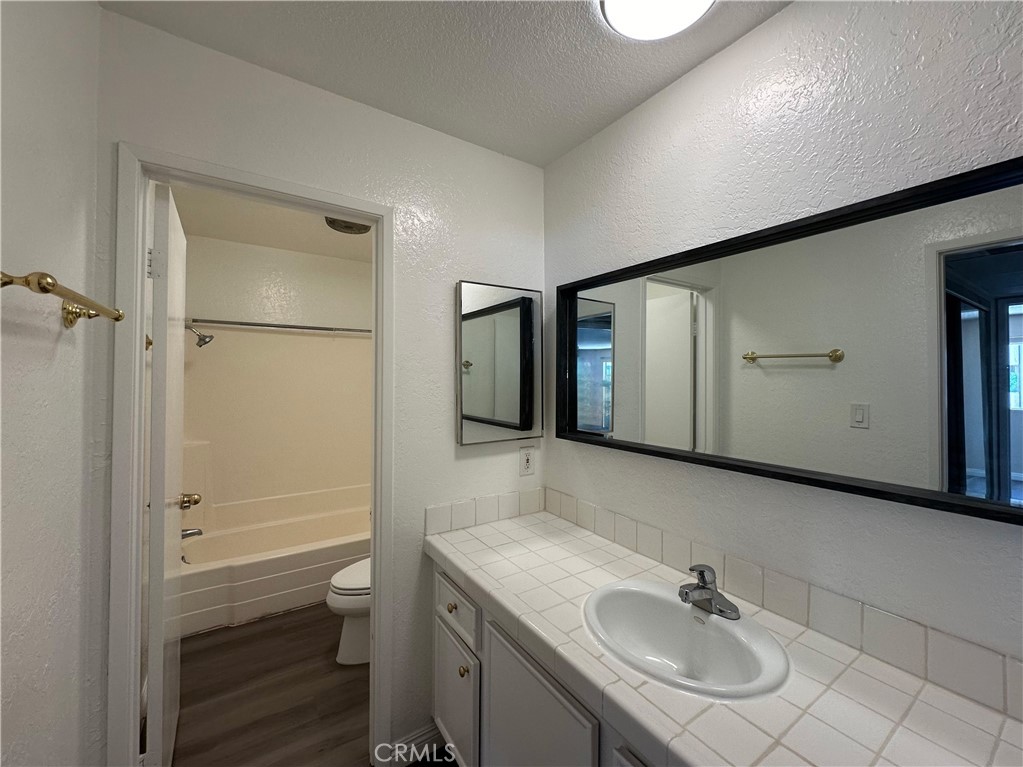 2386 East Del Mar Boulevard, Unit 203 Pasadena, CA 91107 - Photo 21 of 28 a bathroom with a sink a toilet and shower