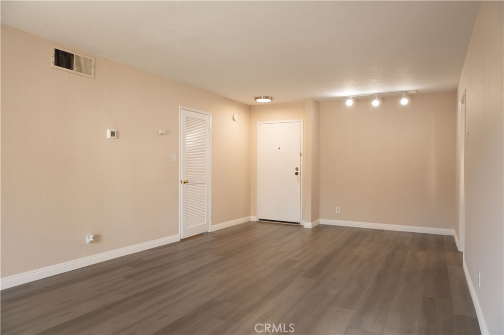 2386 East Del Mar Boulevard, Unit 203 Pasadena, CA 91107 - Photo 3 of 28 a view of an empty room with wooden floor