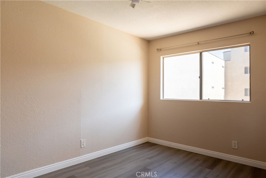 2386 East Del Mar Boulevard, Unit 203 Pasadena, CA 91107 - Photo 6 of 28 wooden floor in an empty room with a window