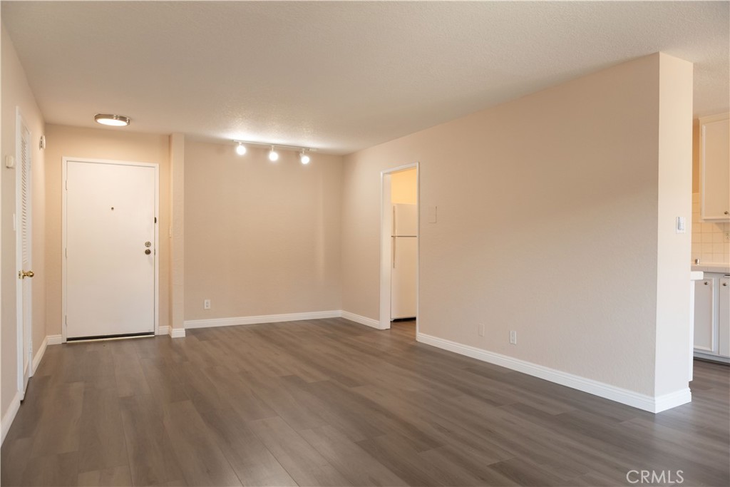 2386 East Del Mar Boulevard, Unit 203 Pasadena, CA 91107 - Photo 7 of 28 an empty room with wooden floor & window