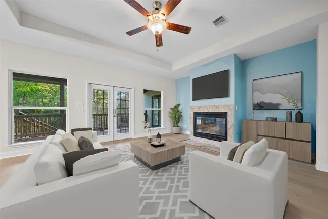 a living room with furniture fireplace and a large window