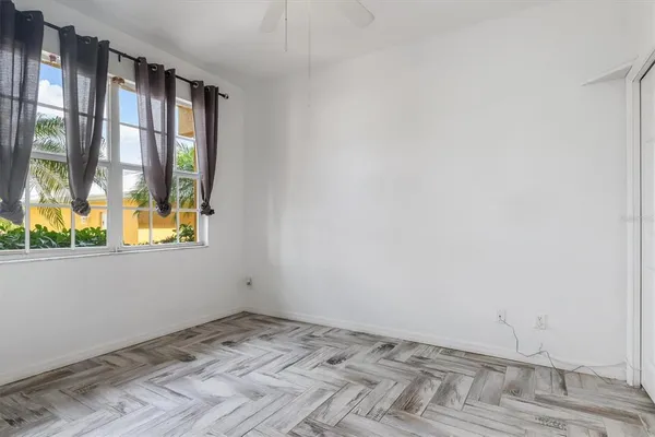 an empty room with windows and entrance