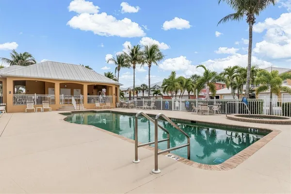 a view of swimming pool with palm trees
