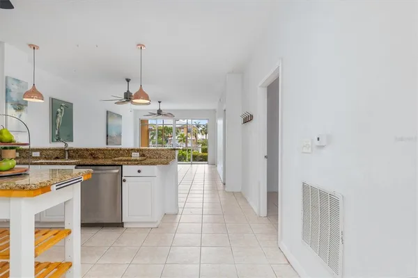 a kitchen with a sink a stove top oven and cabinets