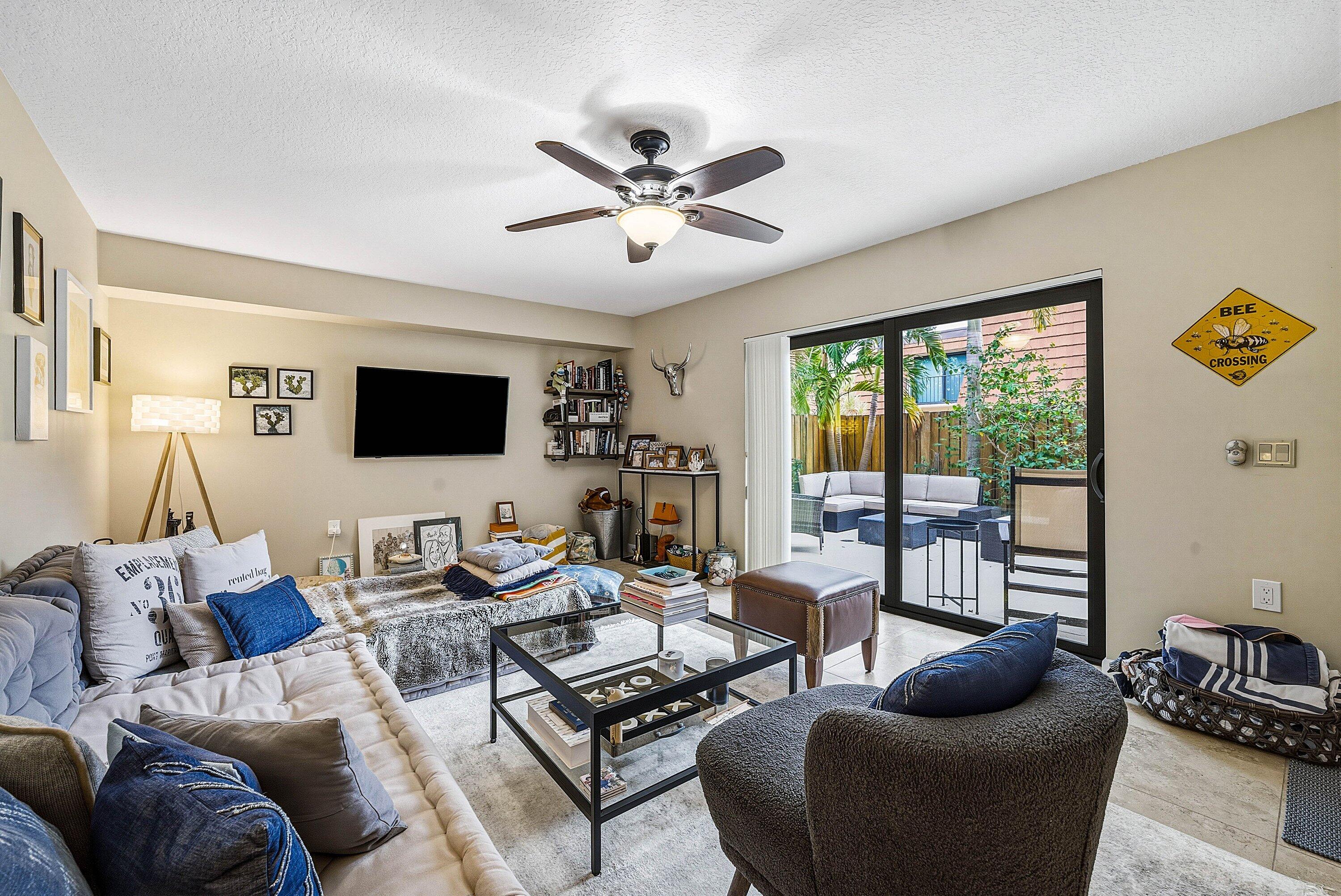 2715 27th Court Jupiter, FL 33477 - Photo 12 of 22 a living room with furniture and a flat screen tv