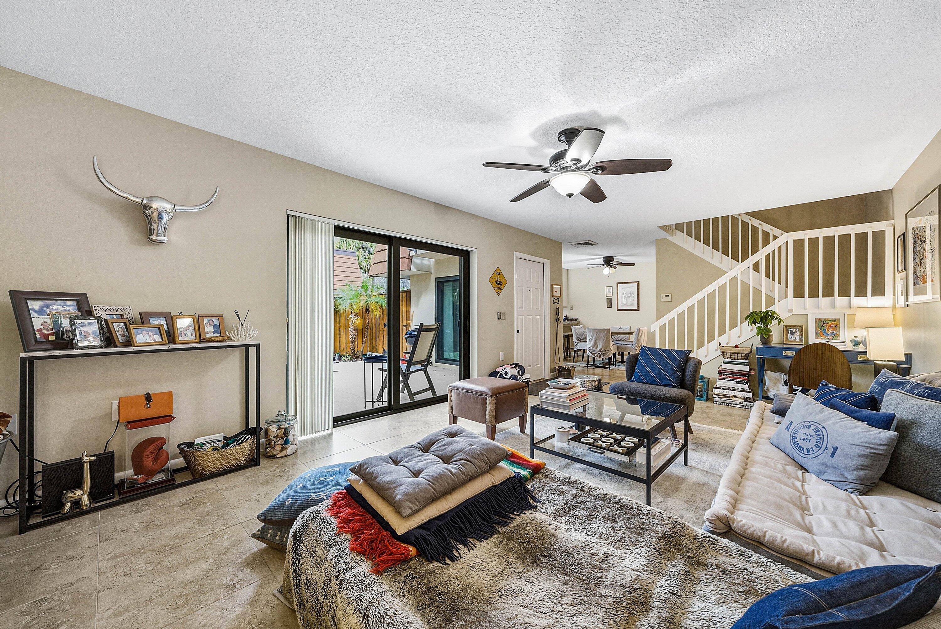2715 27th Court Jupiter, FL 33477 - Photo 13 of 22 a living room with furniture a rug and a chandelier