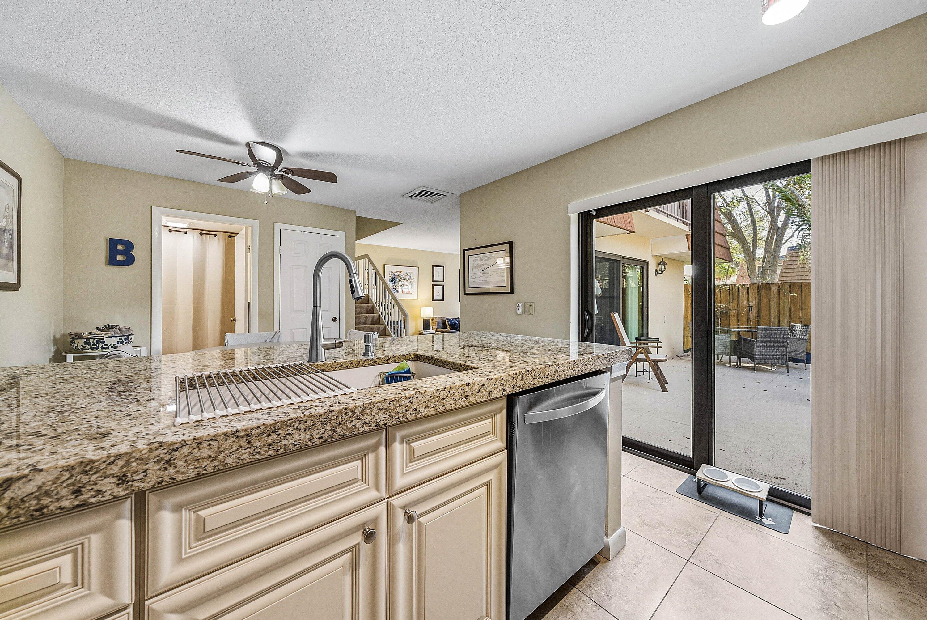 2715 27th Court Jupiter, FL 33477 - Photo 15 of 22 a kitchen with a sink and a refrigerator