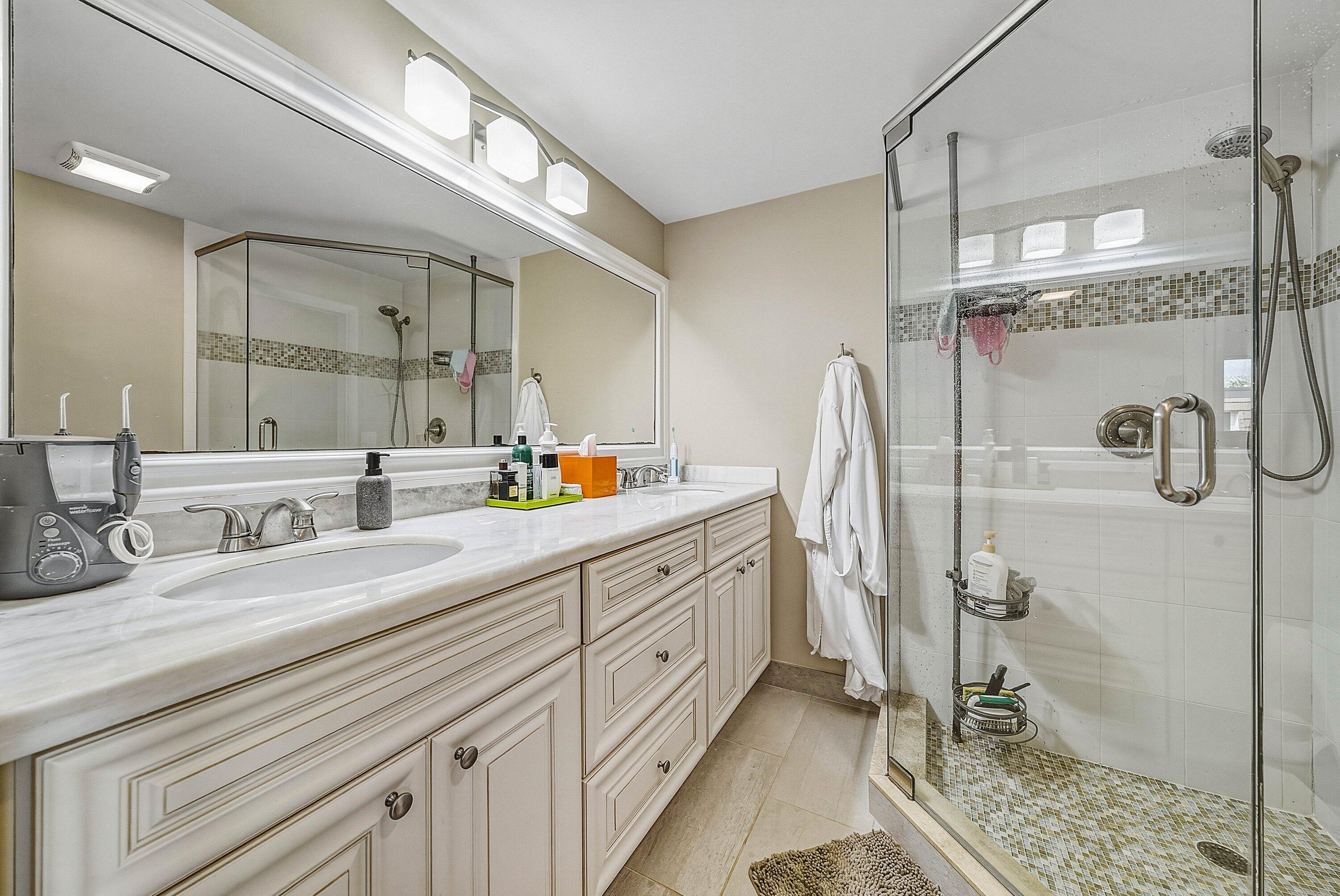 2715 27th Court Jupiter, FL 33477 - Photo 20 of 22 a spacious bathroom with double sink and shower