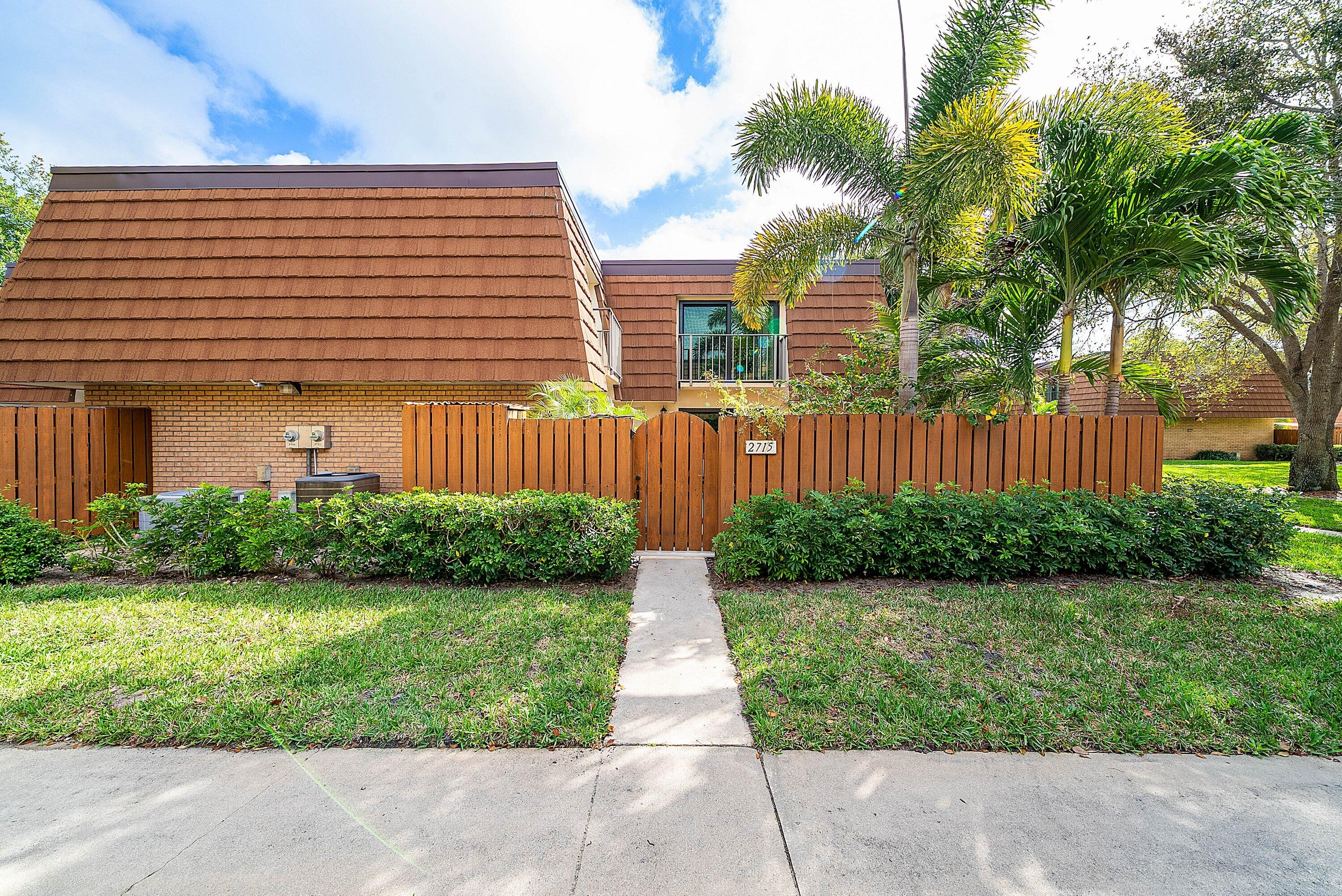 2715 27th Court Jupiter, FL 33477 - Photo 6 of 22 a front view of a house with garden