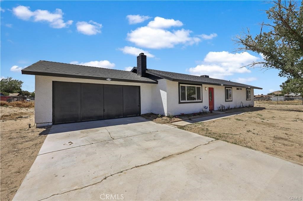 40635 159th Street East Lancaster, CA 93535 - Photo 2 of 25 a front view of a house with a yard and garage