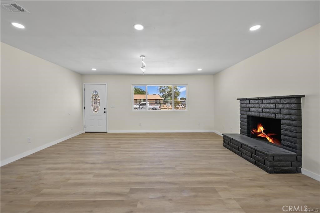 40635 159th Street East Lancaster, CA 93535 - Photo 24 of 25 a view of an empty room with a fireplace and a window
