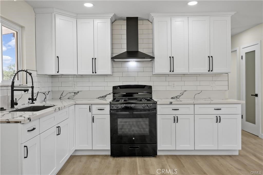 40635 159th Street East Lancaster, CA 93535 - Photo 4 of 25 a kitchen with stainless steel appliances granite countertop white cabinets and a stove