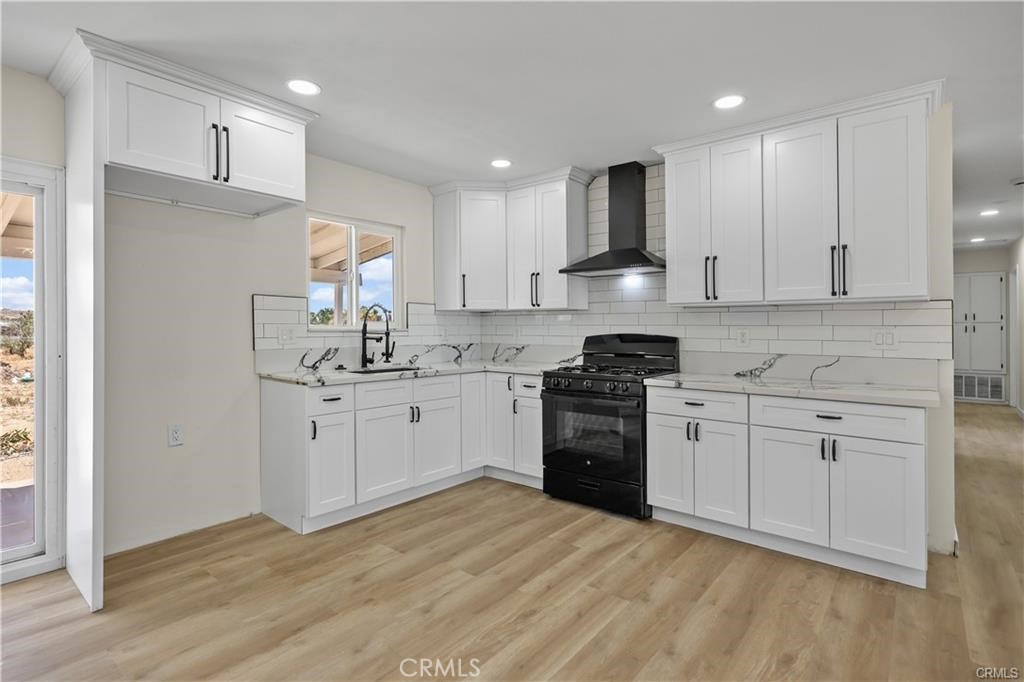 40635 159th Street East Lancaster, CA 93535 - Photo 5 of 25 a kitchen with a sink white cabinets and stainless steel appliances