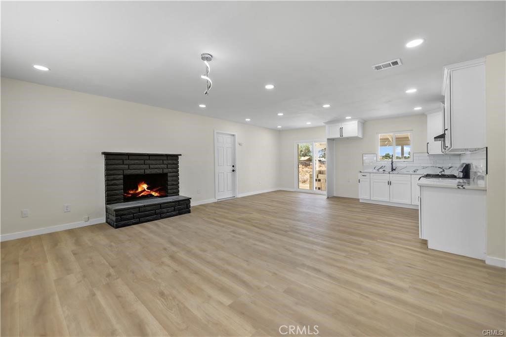40635 159th Street East Lancaster, CA 93535 - Photo 9 of 25 a view of kitchen and a fireplace with wooden floor