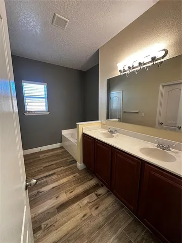 a spacious bathroom with a double vanity sink and a mirror