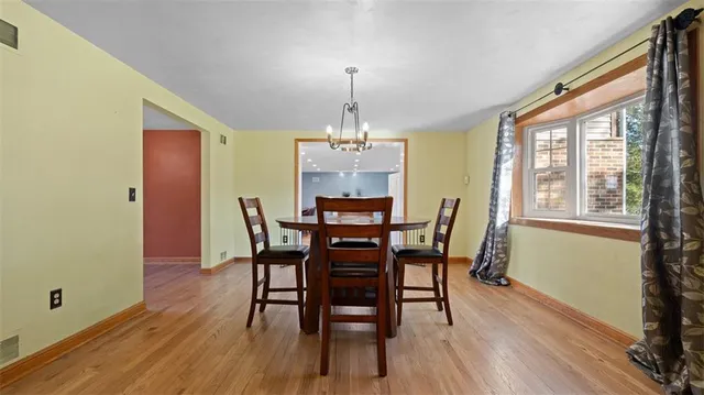 a dining room with furniture window and wooden floor