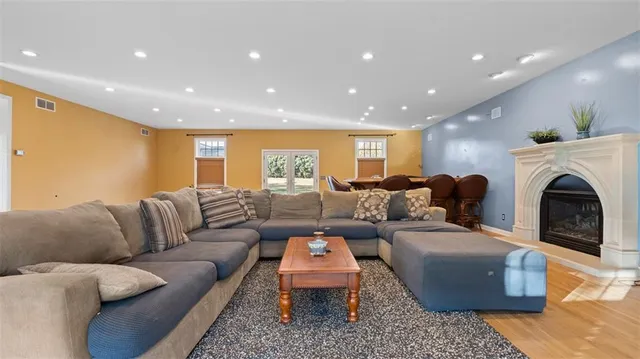 a living room with furniture a fireplace and a rug