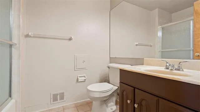 a bathroom with a toilet a sink a vanity and mirror