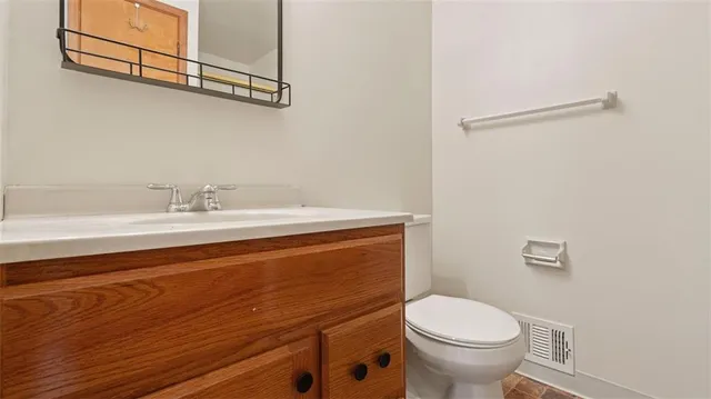 a bathroom with a sink a toilet and mirror