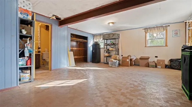 a view of a livingroom with closet and a couch