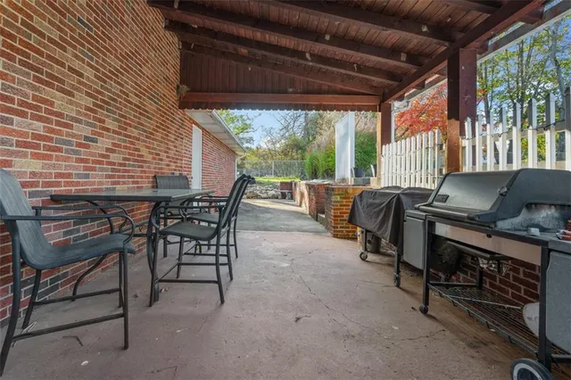 a view of a patio with a table and chairs