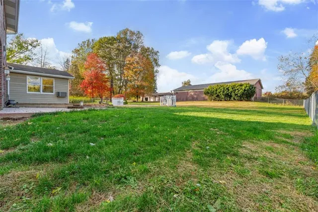 a view of a big yard with a house in the background