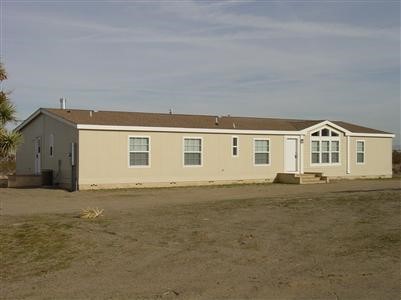 12425 Lebec Road Phelan, CA 92371 - Photo 1 of 1 a front view of a house with a yard