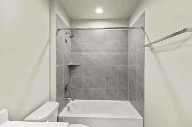 a bathroom with a shower and a toilet