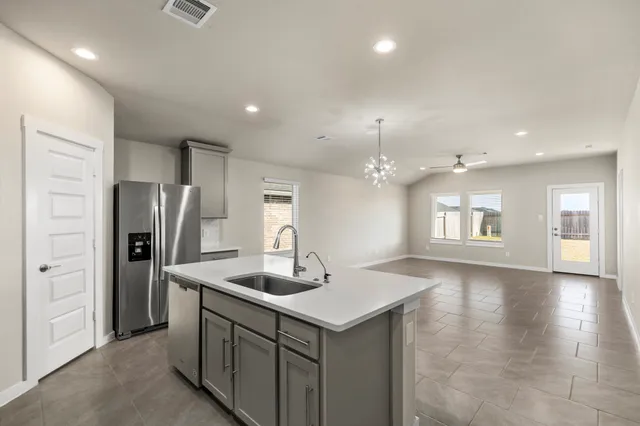 a kitchen with refrigerator and window