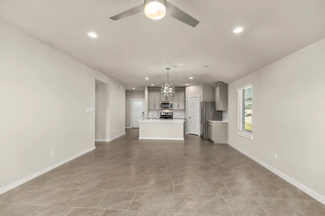 a view of a kitchen with a sink and dishwasher a refrigerator with wooden floor