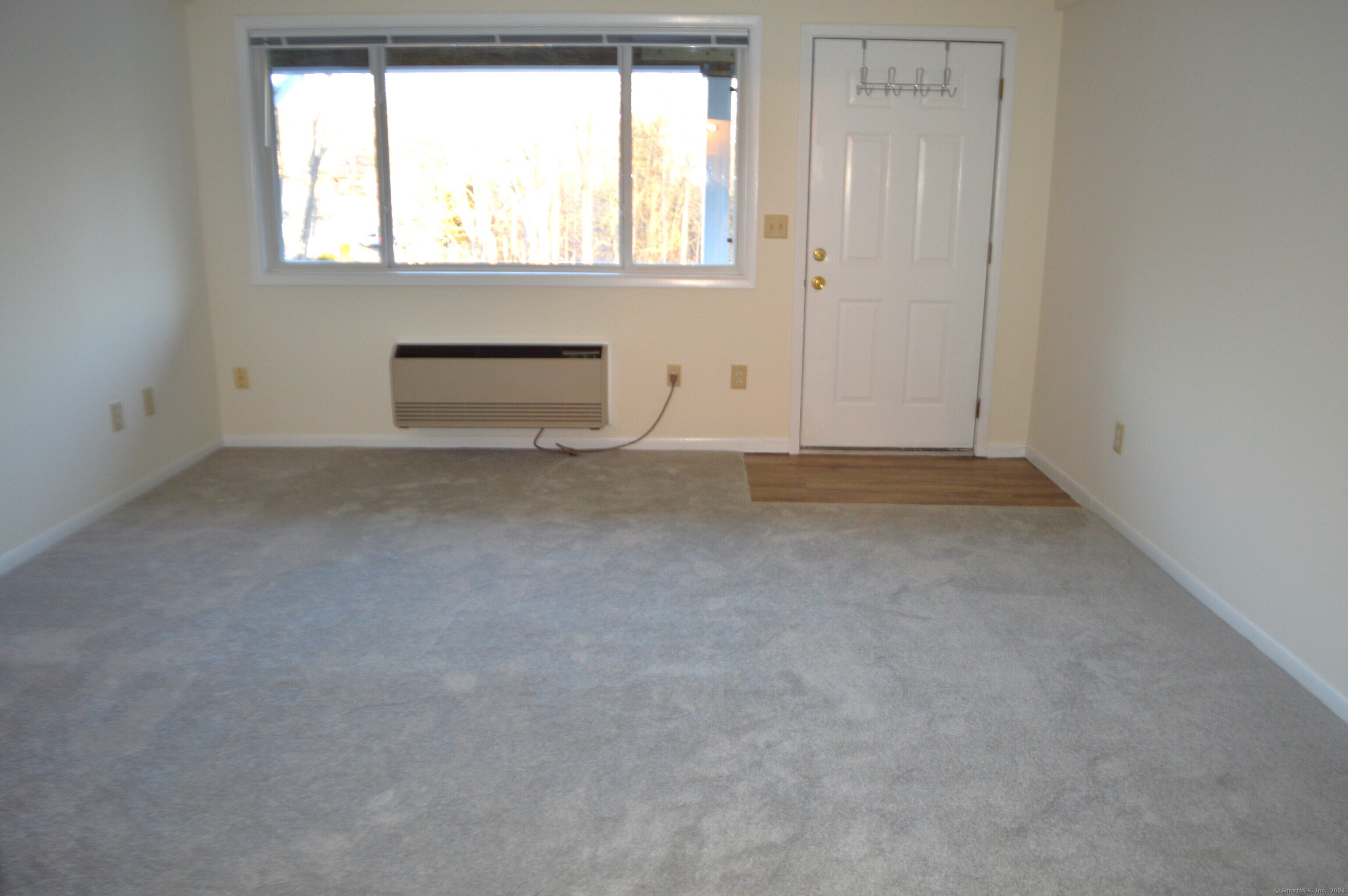17 Kohanza Street, Unit 8 Danbury, CT 06811 - Photo 2 of 7 an empty room with a window