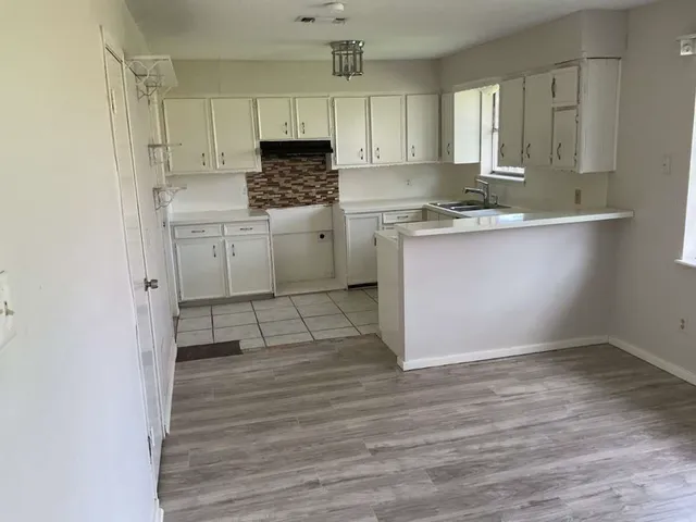 a kitchen with a sink cabinets and window