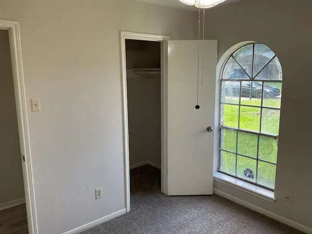a view of room with window and hallway