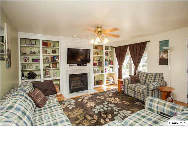 21 Hatchechubee Road Palmyra, VA 22963 - Photo 8 of 17 Family room features built in book cases, hardwood floors & a gas log fireplace.