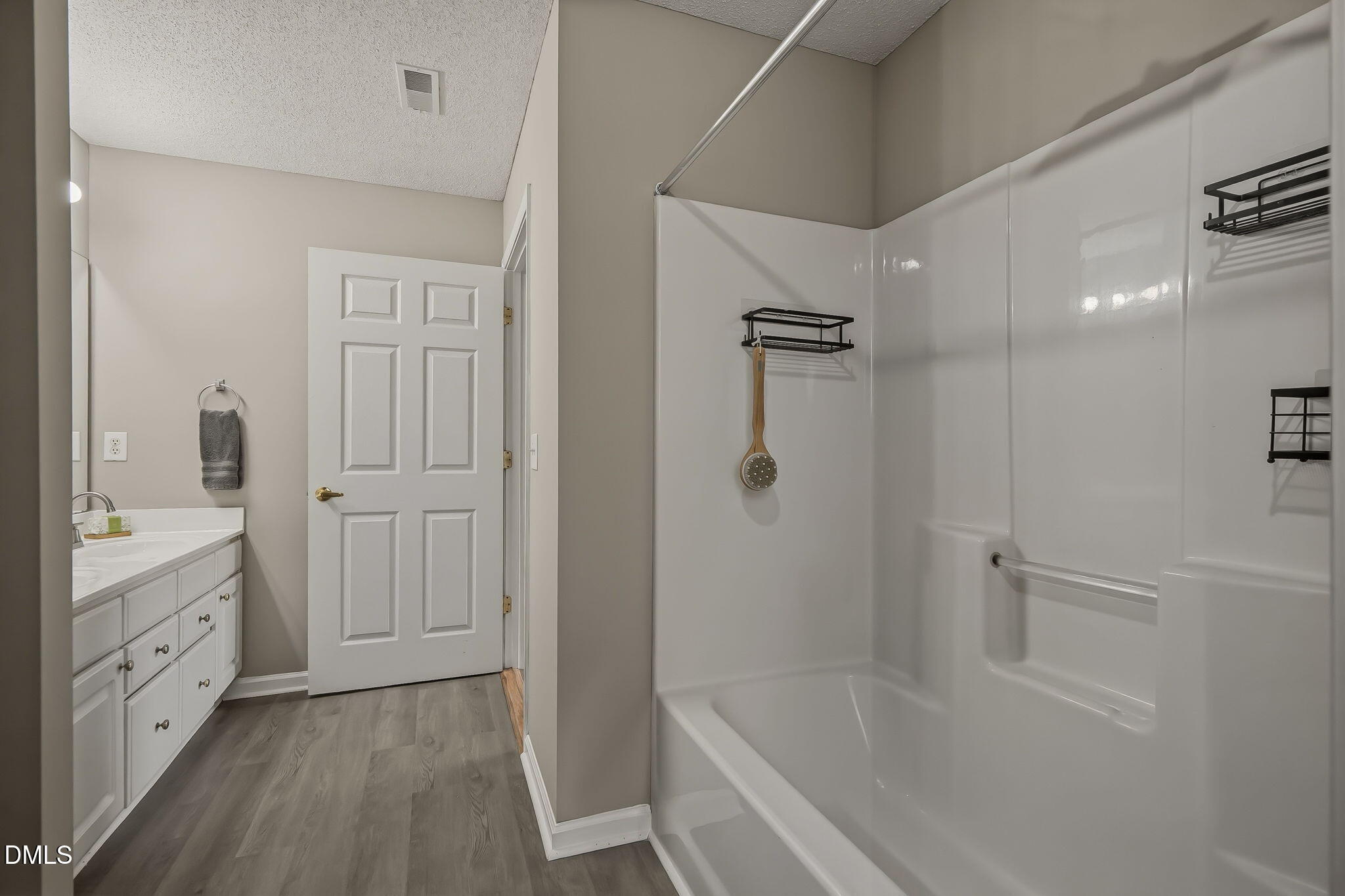 2501 Huntscroft Lane, Unit 100 Raleigh, NC 27617 - Photo 29 of 31 a bathroom with a granite countertop sink a toilet and shower