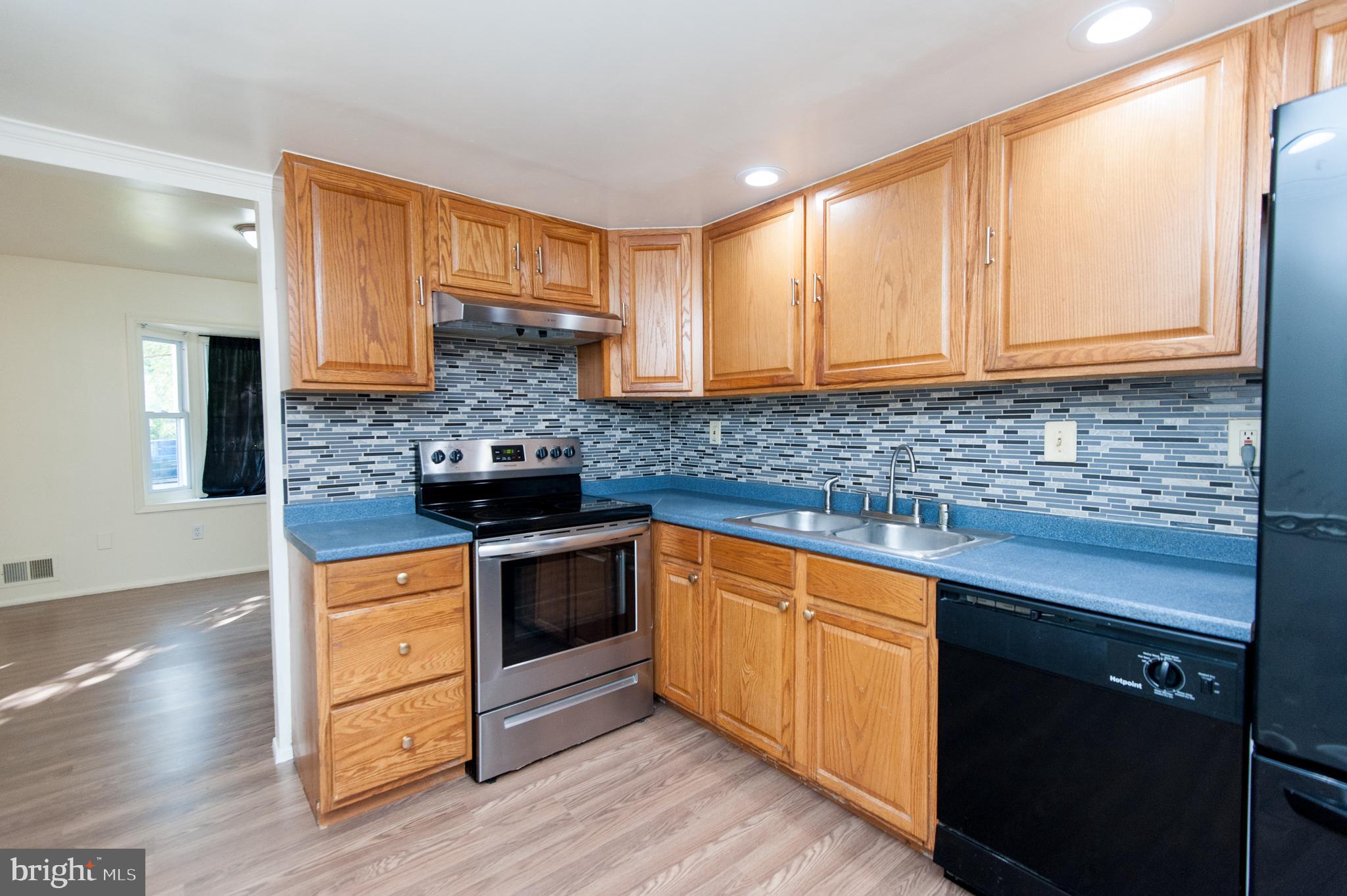 12013 Pheasant Run Drive Laurel, MD 20708 - Photo 11 of 34 a kitchen with stainless steel appliances granite countertop a stove a sink and a microwave