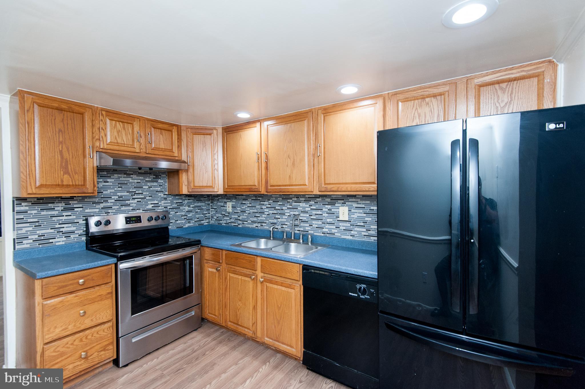 12013 Pheasant Run Drive Laurel, MD 20708 - Photo 12 of 34 a kitchen with granite countertop stainless steel appliances and refrigerator