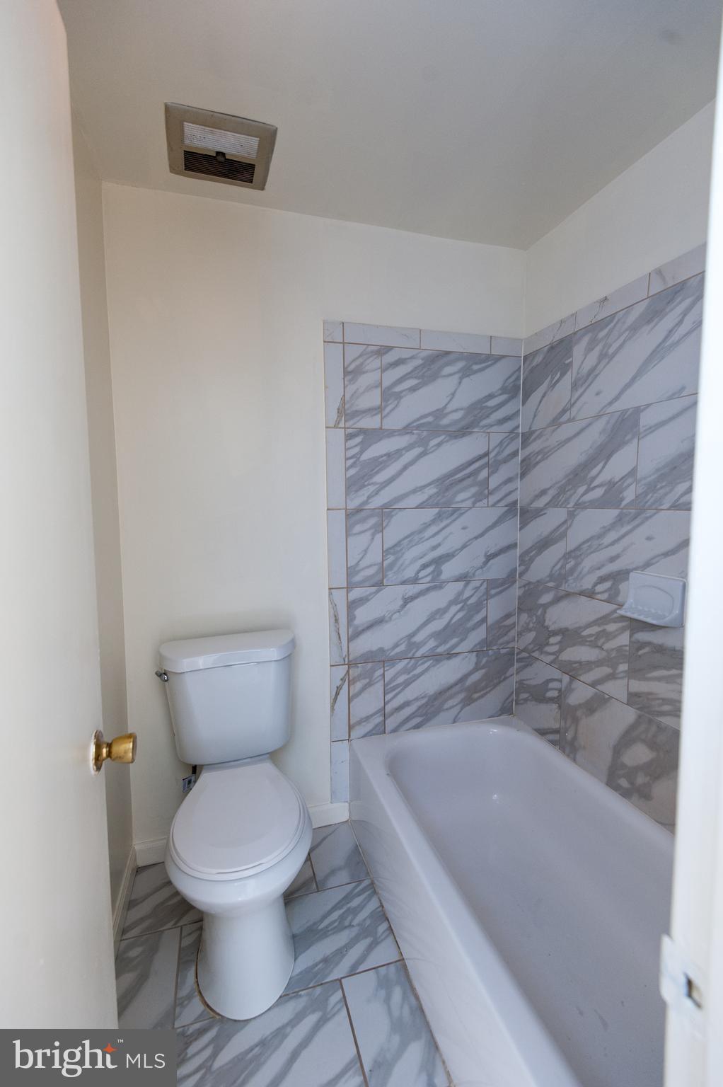 12013 Pheasant Run Drive Laurel, MD 20708 - Photo 22 of 34 a bathroom with a toilet and bathtub