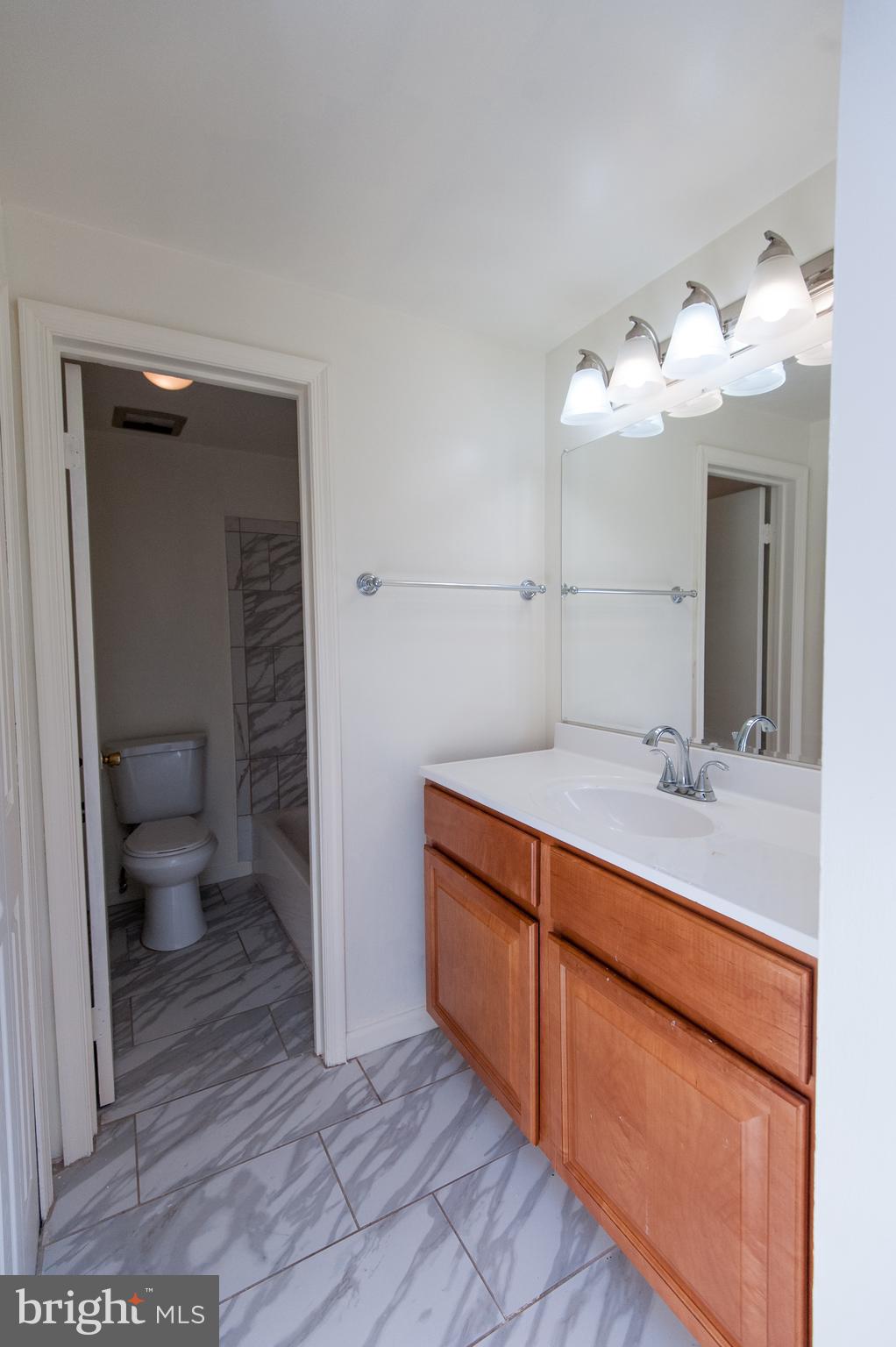 12013 Pheasant Run Drive Laurel, MD 20708 - Photo 23 of 34 a bathroom with a sink and a mirror