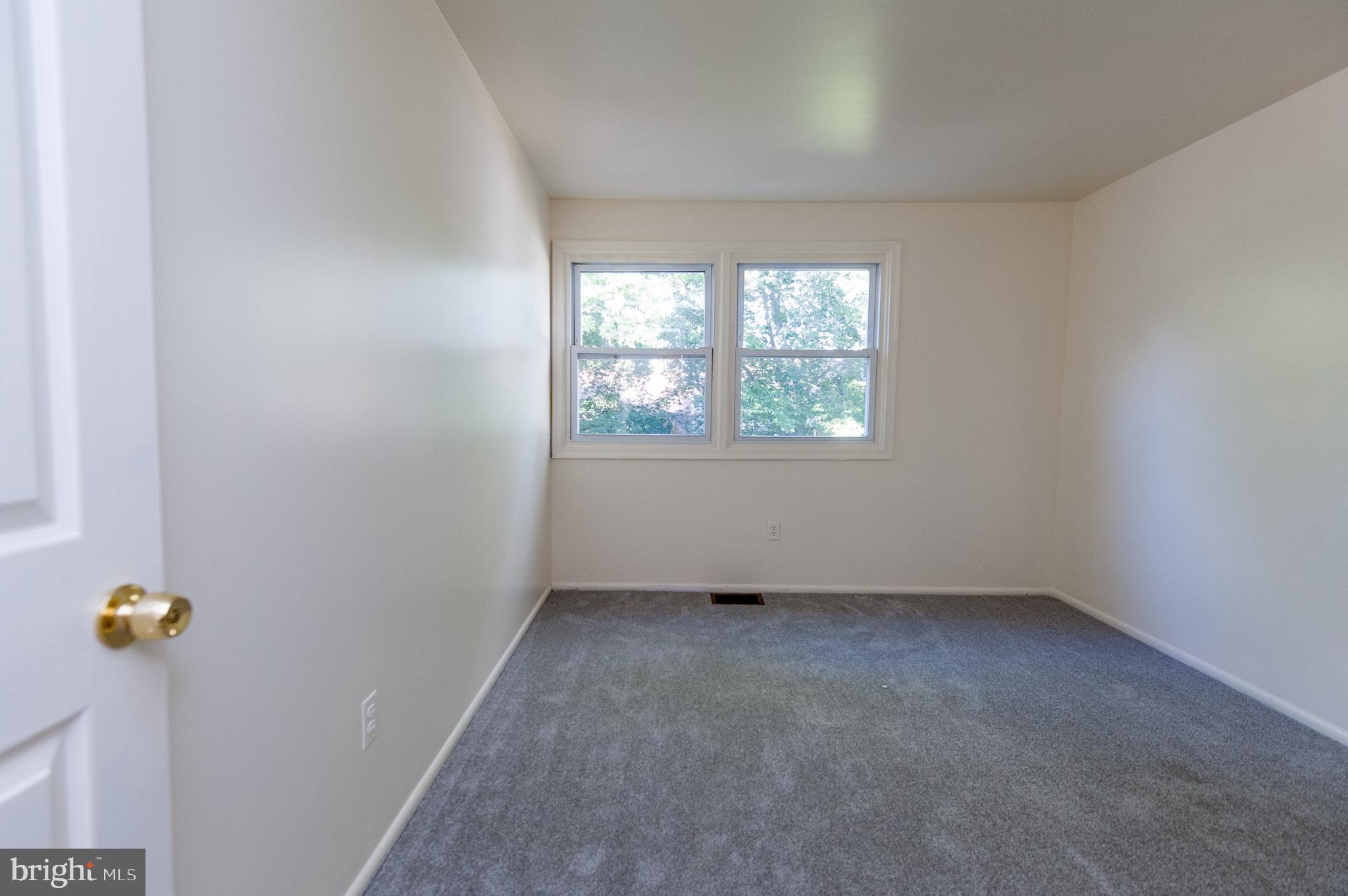 12013 Pheasant Run Drive Laurel, MD 20708 - Photo 27 of 34 an empty room with windows and view of outdoor space