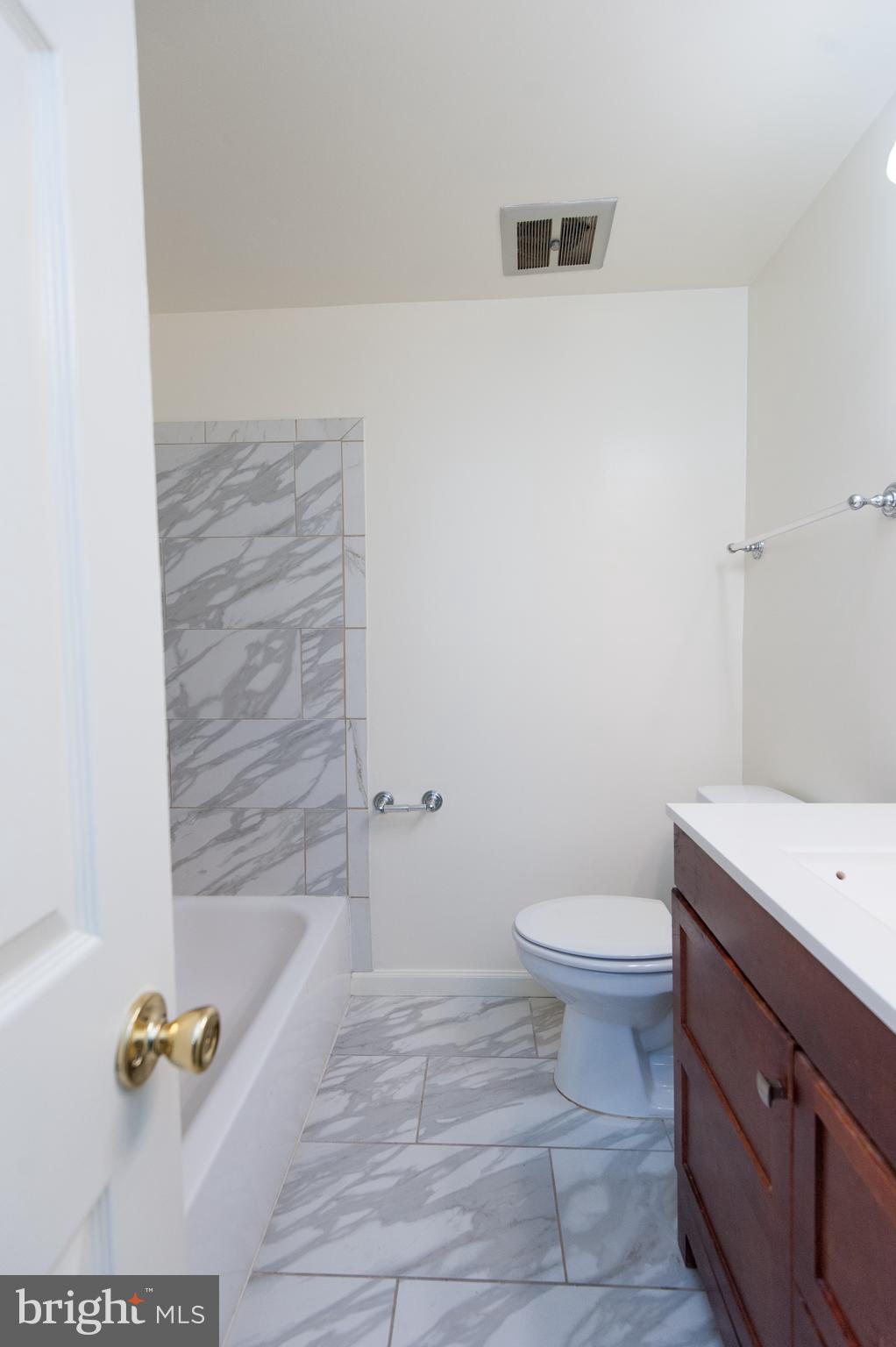 12013 Pheasant Run Drive Laurel, MD 20708 - Photo 31 of 34 a bathroom with a sink a toilet and bathtub