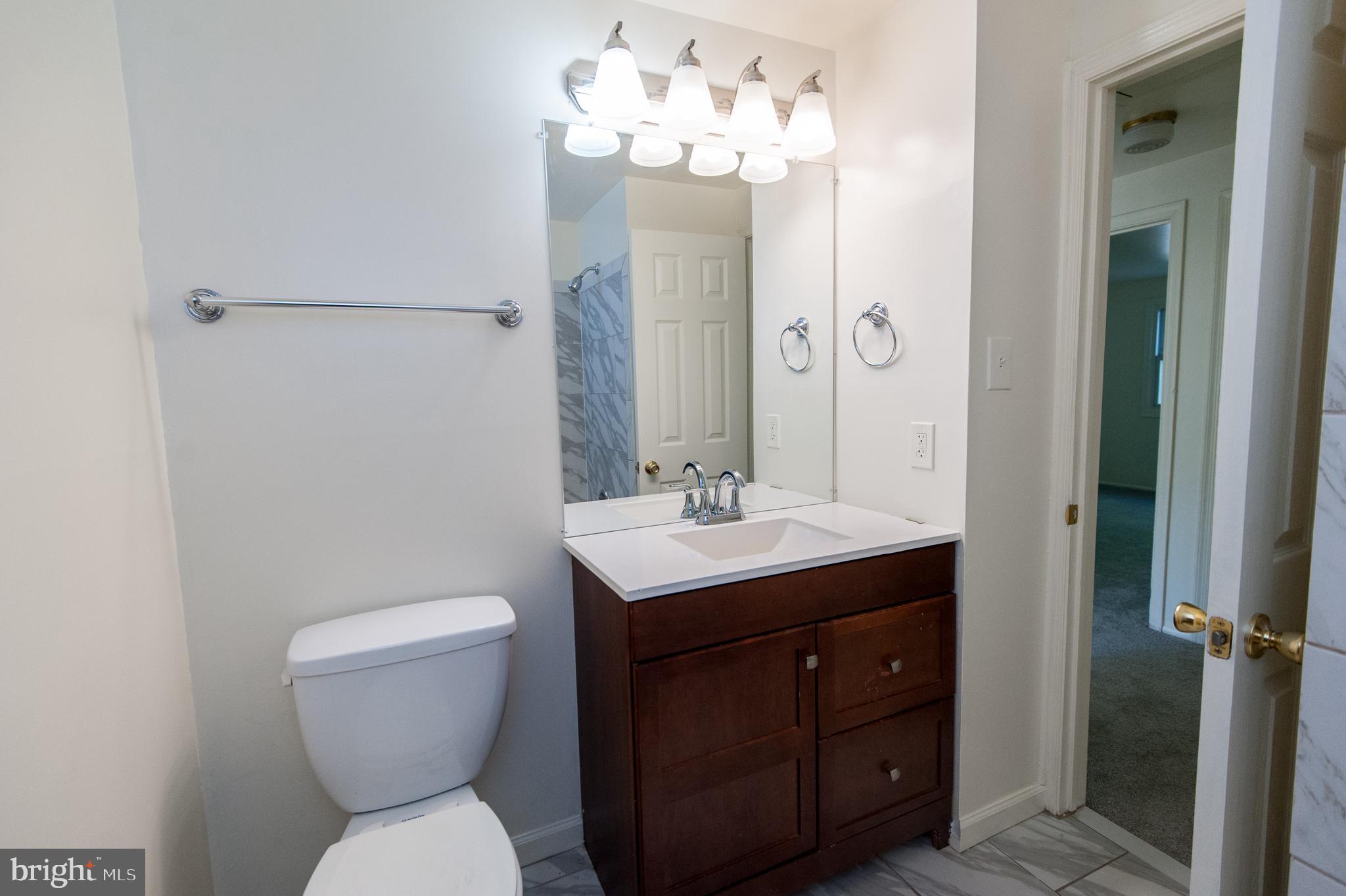 12013 Pheasant Run Drive Laurel, MD 20708 - Photo 32 of 34 a bathroom with a toilet sink and mirror