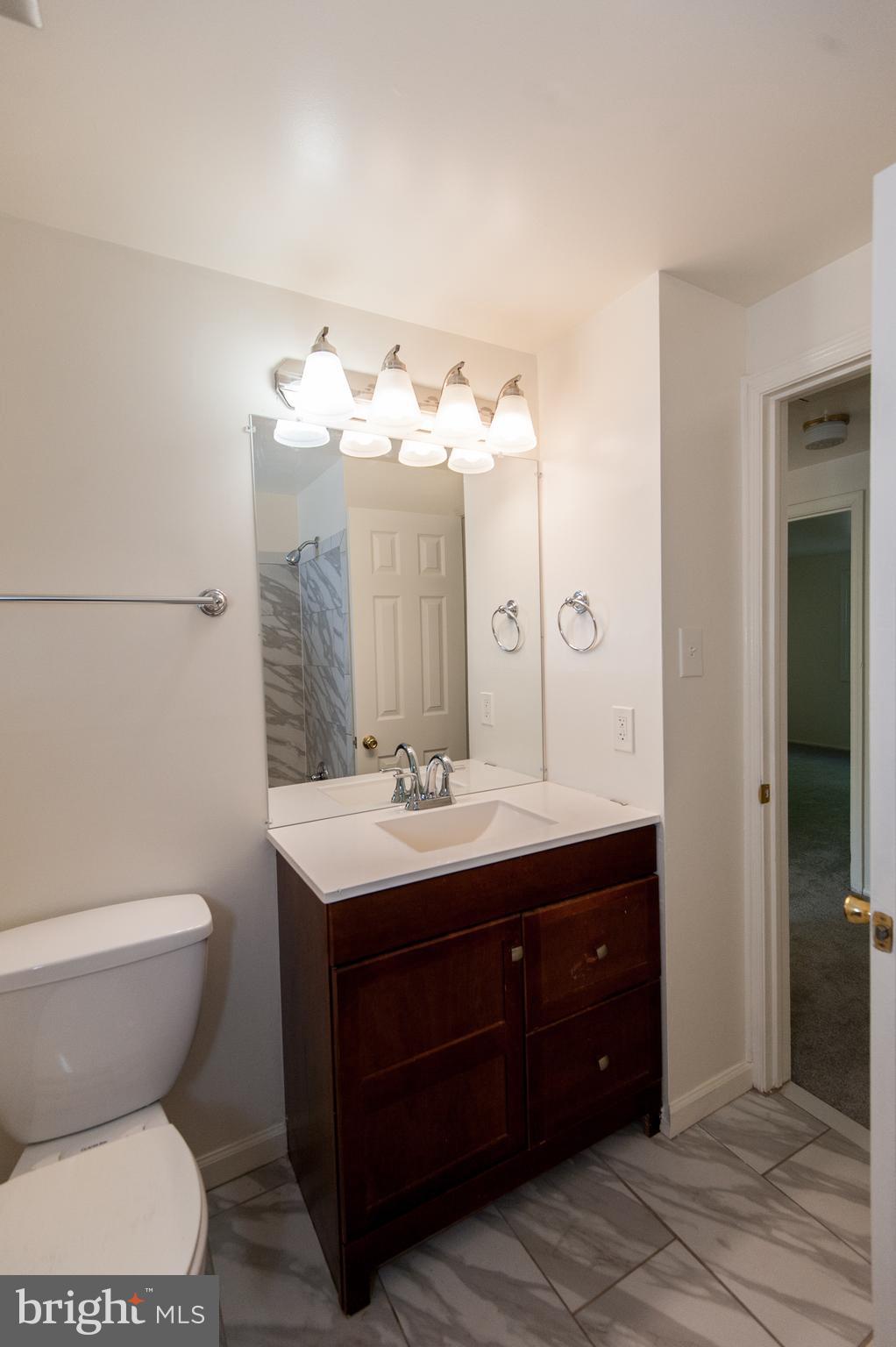 12013 Pheasant Run Drive Laurel, MD 20708 - Photo 33 of 34 a bathroom with a toilet sink and mirror