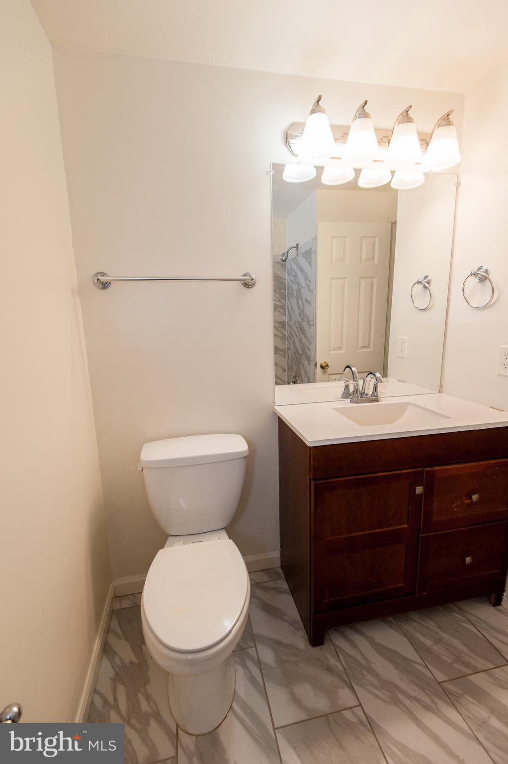 12013 Pheasant Run Drive Laurel, MD 20708 - Photo 34 of 34 a bathroom with a sink and a mirror