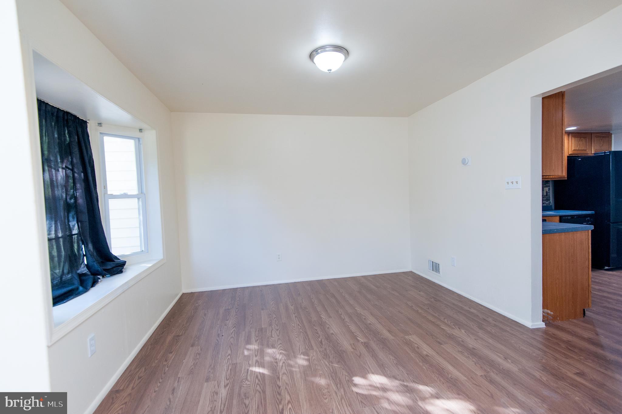 12013 Pheasant Run Drive Laurel, MD 20708 - Photo 6 of 34 wooden floor in an empty room with a window