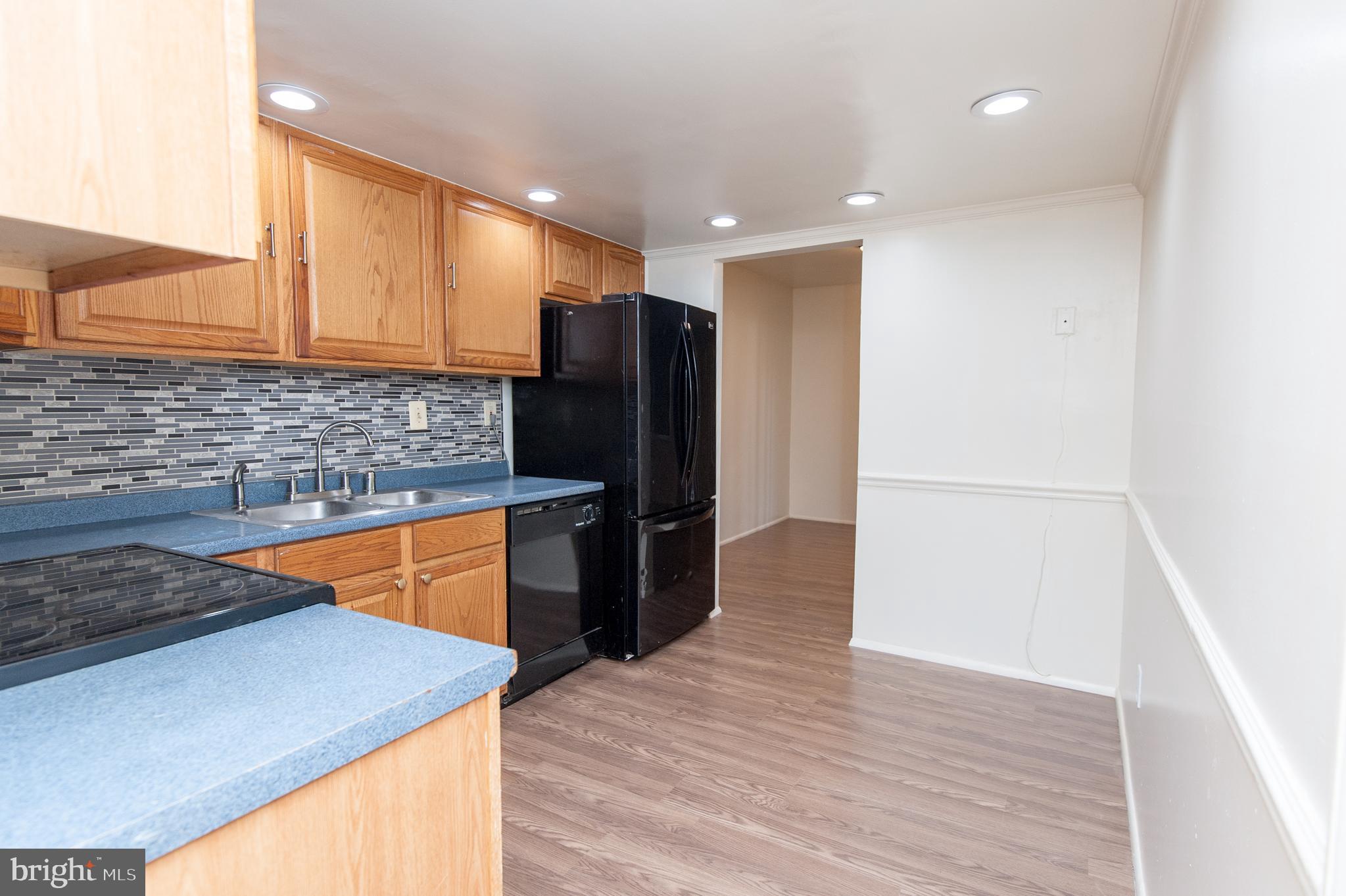 12013 Pheasant Run Drive Laurel, MD 20708 - Photo 8 of 34 a kitchen with stainless steel appliances granite countertop a refrigerator a sink and a stove